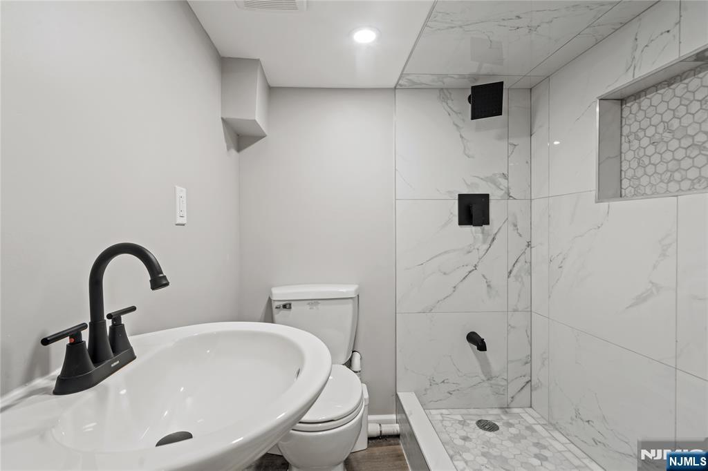 190 Washington Avenue Hackensack, NJ 07601 - Photo 10 of 20 a bathroom with a sink toilet and shower