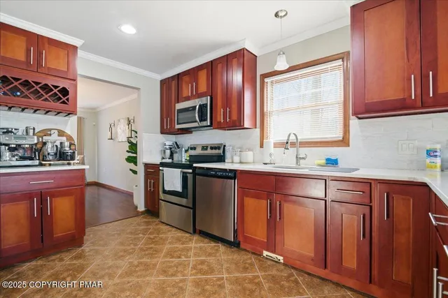 a kitchen with stainless steel appliances granite countertop a stove a sink dishwasher and a refrigerator