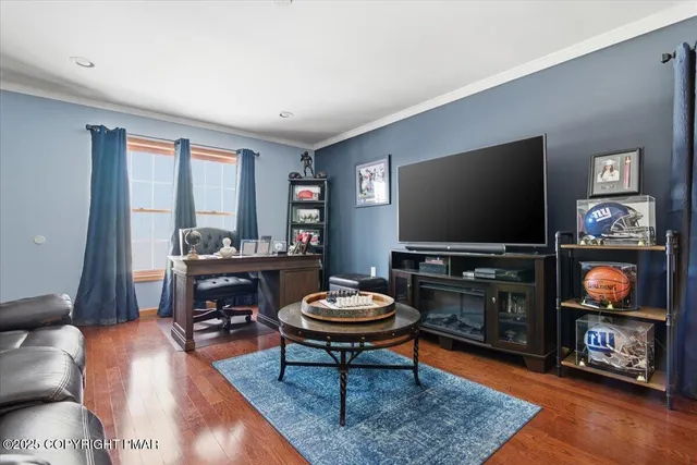 a living room with furniture and a flat screen tv