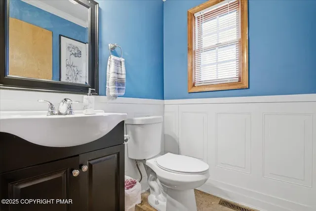 a bathroom with a sink toilet and mirror