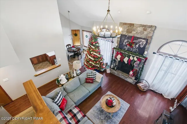 a living room with furniture and a chandelier