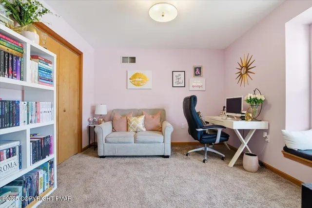 a living room with furniture and a bookshelf