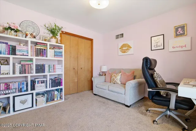 a living room with furniture cabinets and window