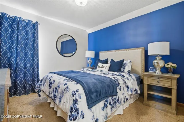 a bedroom with a bed and a lamp