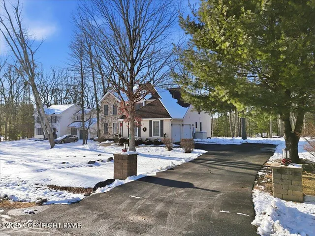 a view of a house with snow on the road