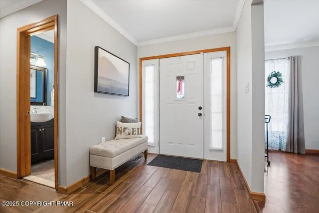 a very nice looking room with wooden floor and a bathroom