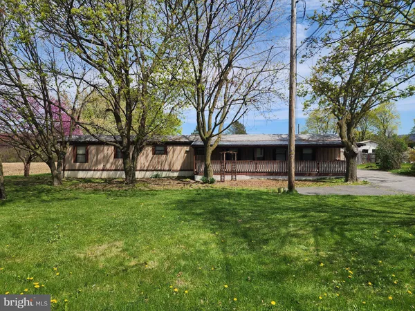 a view of a house with a yard and wooden fence