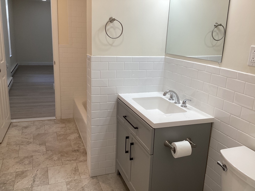 566 Commonwealth Avenue, Unit 101 Boston, MA 02215 - Photo 4 of 17 a bathroom with a sink and mirror