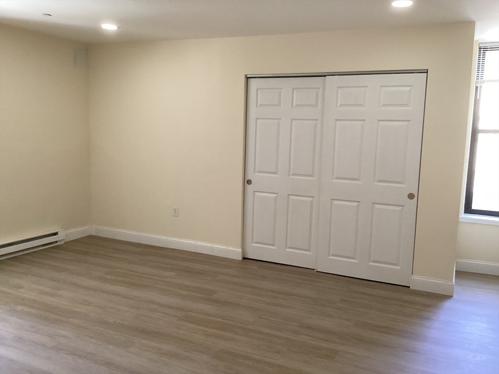 566 Commonwealth Avenue, Unit 101 Boston, MA 02215 - Photo 7 of 17 a view of an empty room with wooden floor