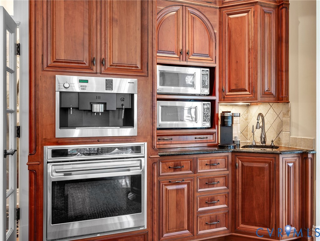 2725 Stonegate Court Midlothian, VA 23113 - Photo 17 of 50 a kitchen with granite countertop cabinets stainless steel appliances and a sink