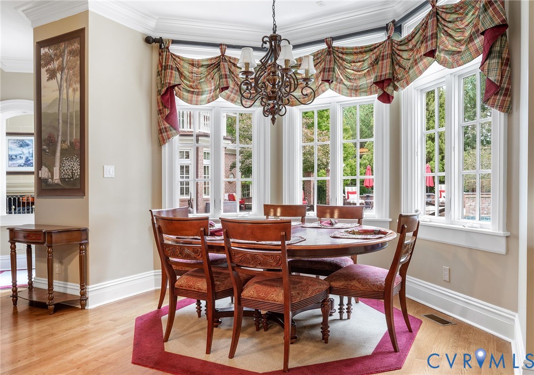 2725 Stonegate Court Midlothian, VA 23113 - Photo 20 of 50 a view of a dining room with furniture wooden floor and chandelier