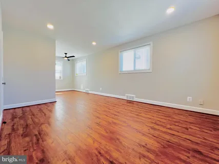 a view of a room with wooden floor and white walls