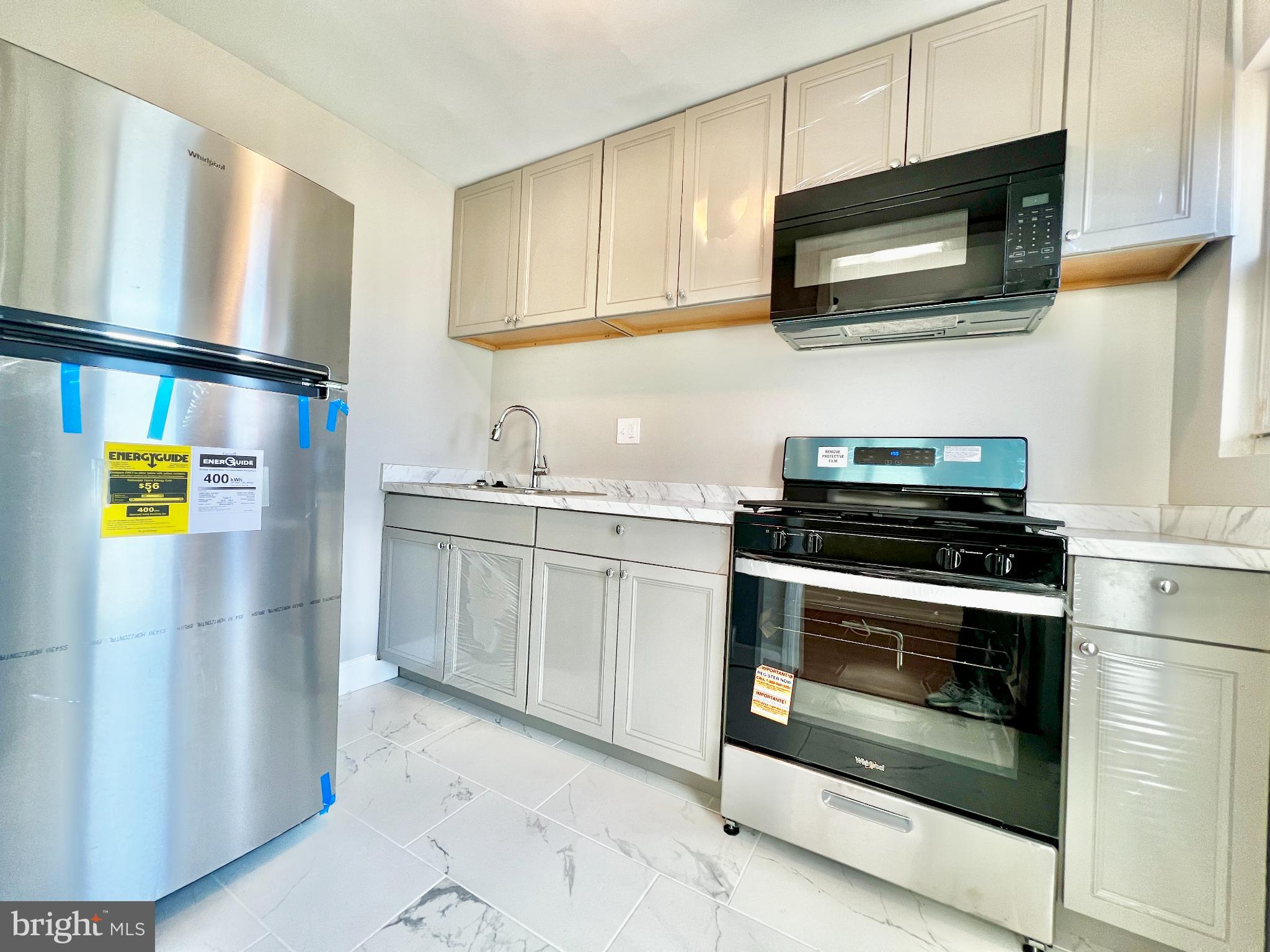 75 58th Street Southeast Washington, DC 20019 - Photo 5 of 40 a kitchen with stainless steel appliances a stove microwave and sink