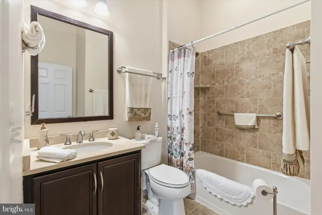 a bedroom with a bed chandelier and a window