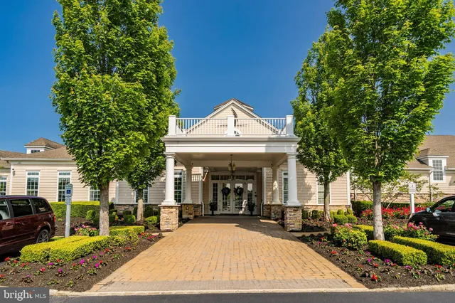 a kitchen with granite countertop a stove a sink and white cabinets