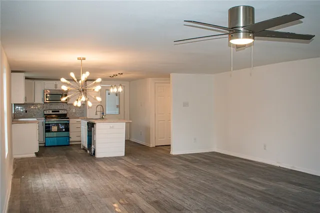 a view of a room with kitchen and chandelier