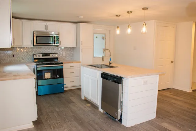 a kitchen with a stove and a microwave