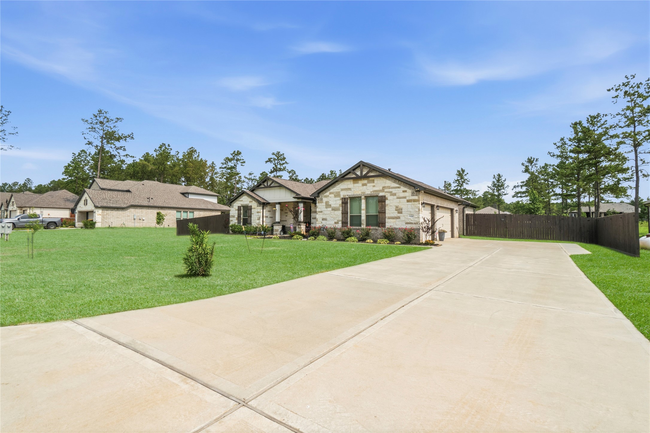 13447 Maverick Trail Road Conroe, TX 77303 - Photo 34 of 48 This beautifully maintained home offers striking curb appeal with manicured landscaping, stone accents, and an oversized driveway with plenty of parking.