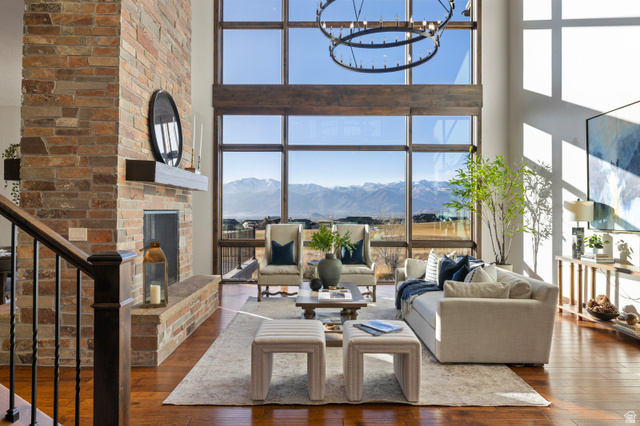 707 Chimney Rock Road, Unit 247 Heber City, UT 84032 - Photo 4 of 64 Living room with a fireplace, a high ceiling, dark wood finished floors, a mountain view, and stairs