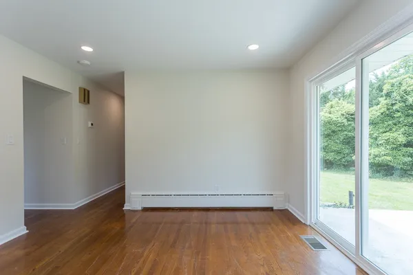 a view of a big room with wooden floor and doors