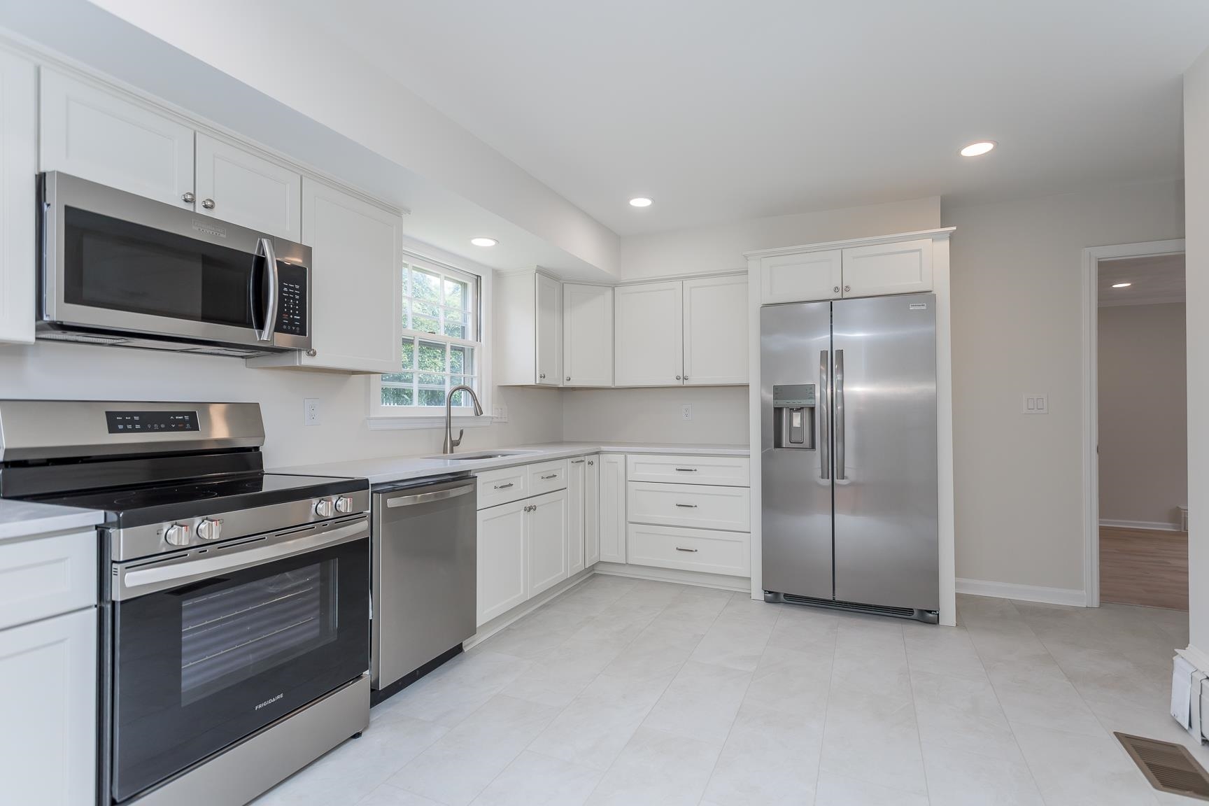 1002 North Coalter Street Staunton, VA 24401 - Photo 16 of 36 a kitchen with stainless steel appliances granite countertop a stove a sink and a microwave