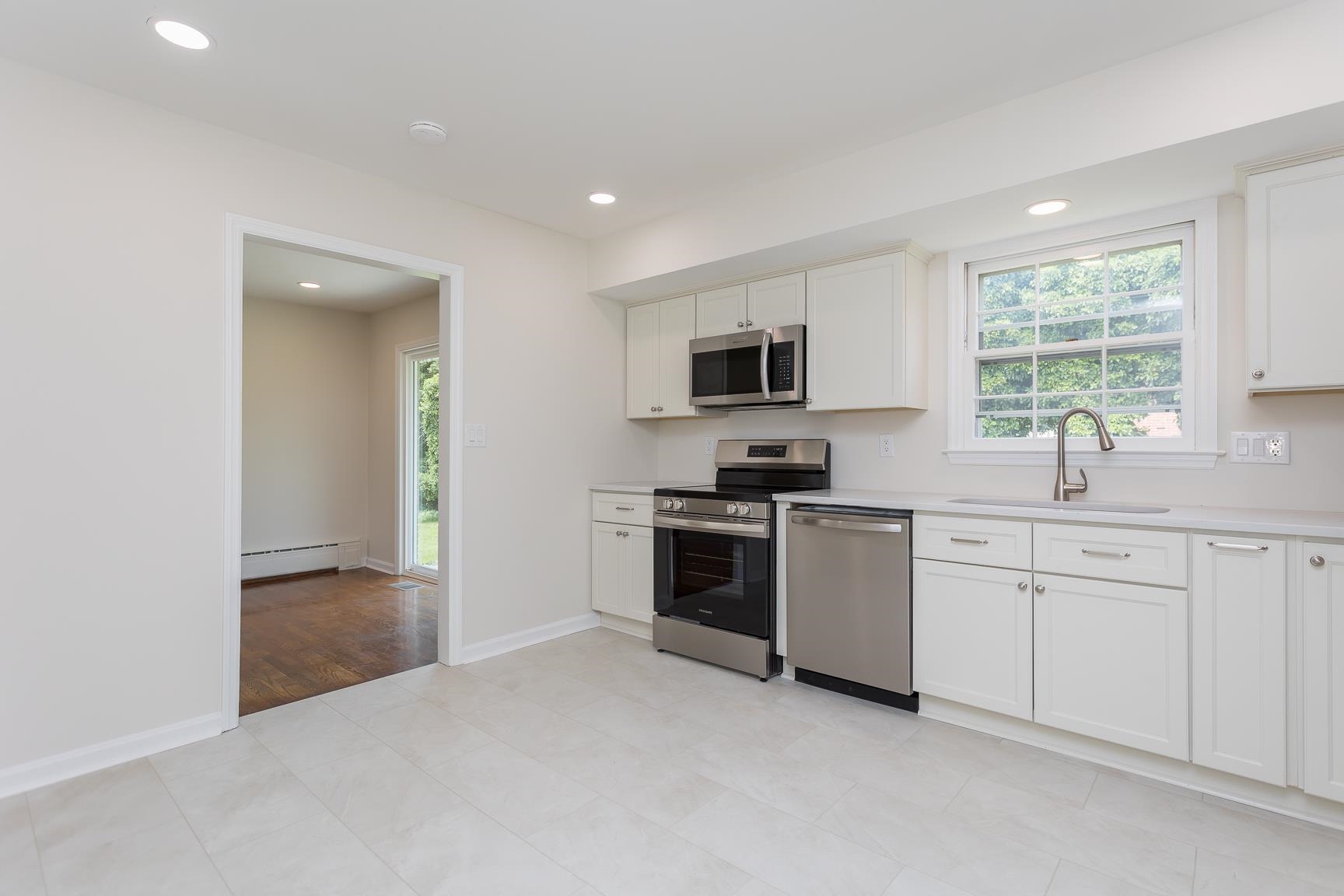 1002 North Coalter Street Staunton, VA 24401 - Photo 18 of 36 a kitchen with cabinets stainless steel appliances and window