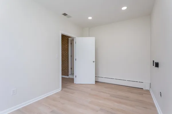 an empty room with wooden floor