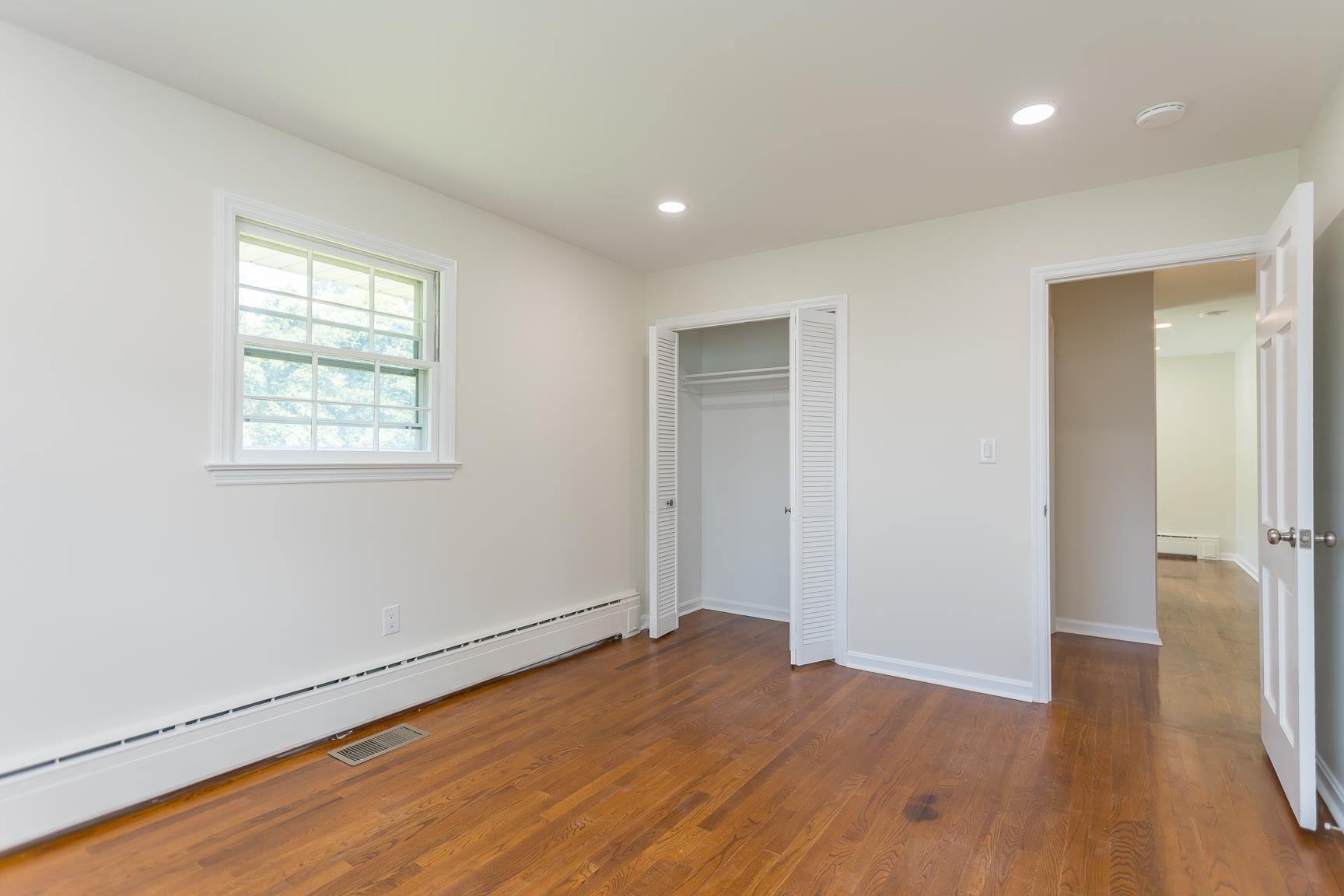 1002 North Coalter Street Staunton, VA 24401 - Photo 28 of 36 an empty room with wooden floor and a window