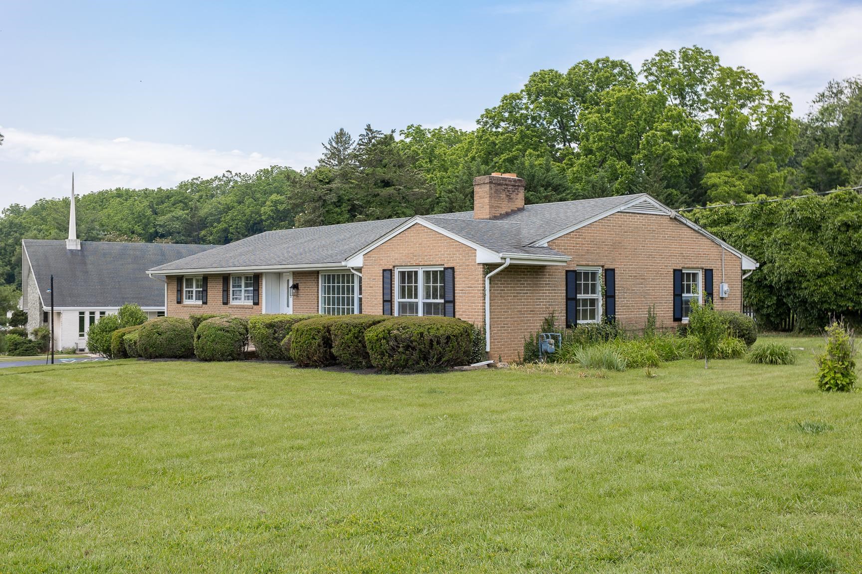 1002 North Coalter Street Staunton, VA 24401 - Photo 3 of 36 a front view of a house with a yard and garage