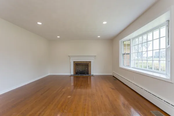 wooden floor in an empty room with a window