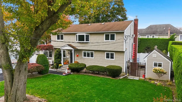 a aerial view of a house next to a yard