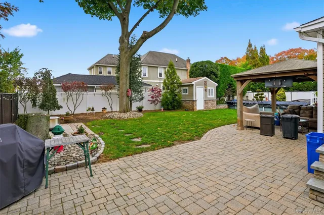 a view of a house with backyard porch and sitting area
