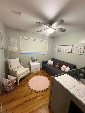 a bedroom with furniture and a wooden floor