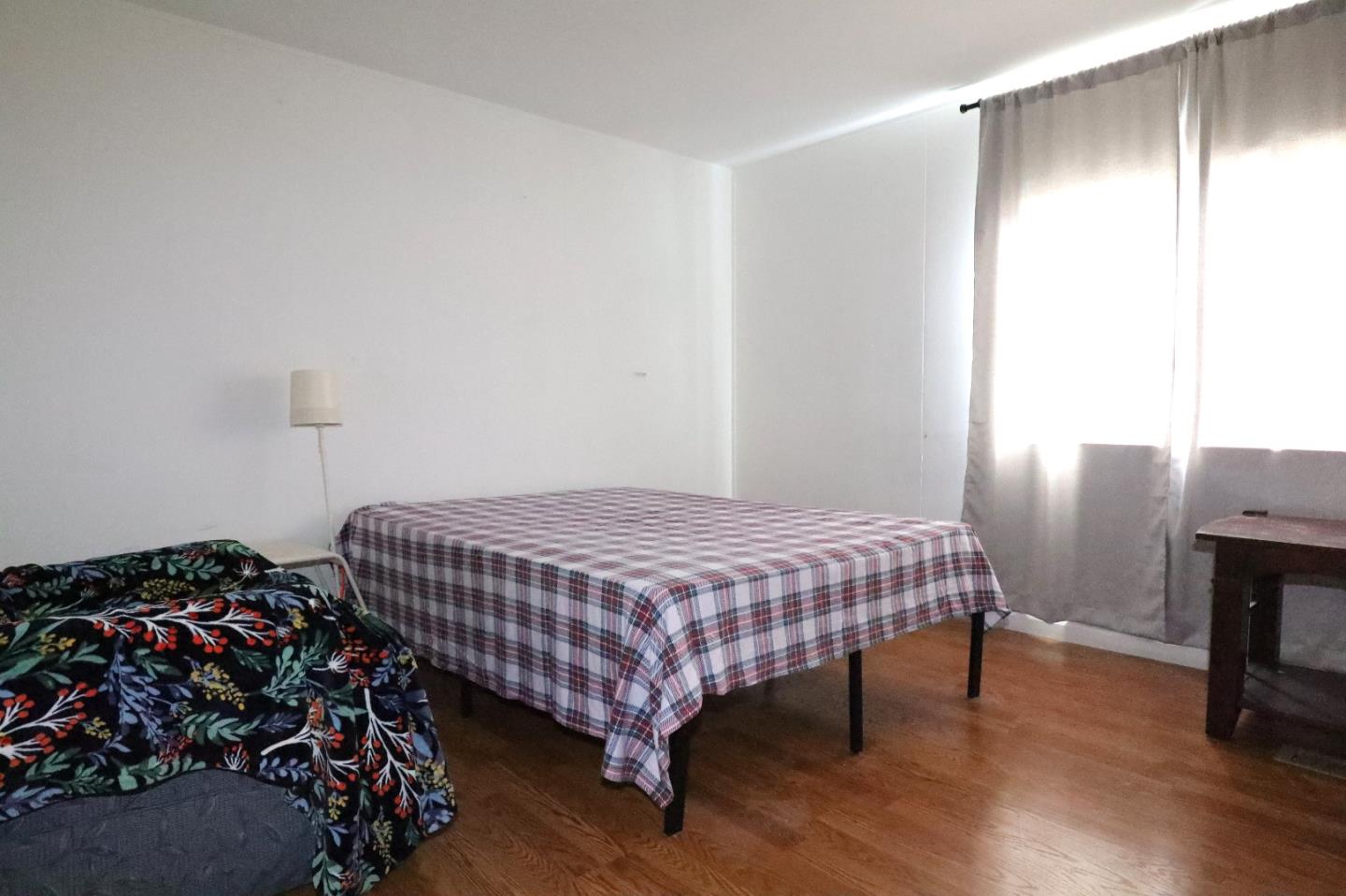 60 Wilson Way, Unit 150 Milpitas, CA 95035 - Photo 12 of 12 a bedroom with a bed and wooden floor