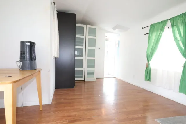 a view of a kitchen with a sink and a window