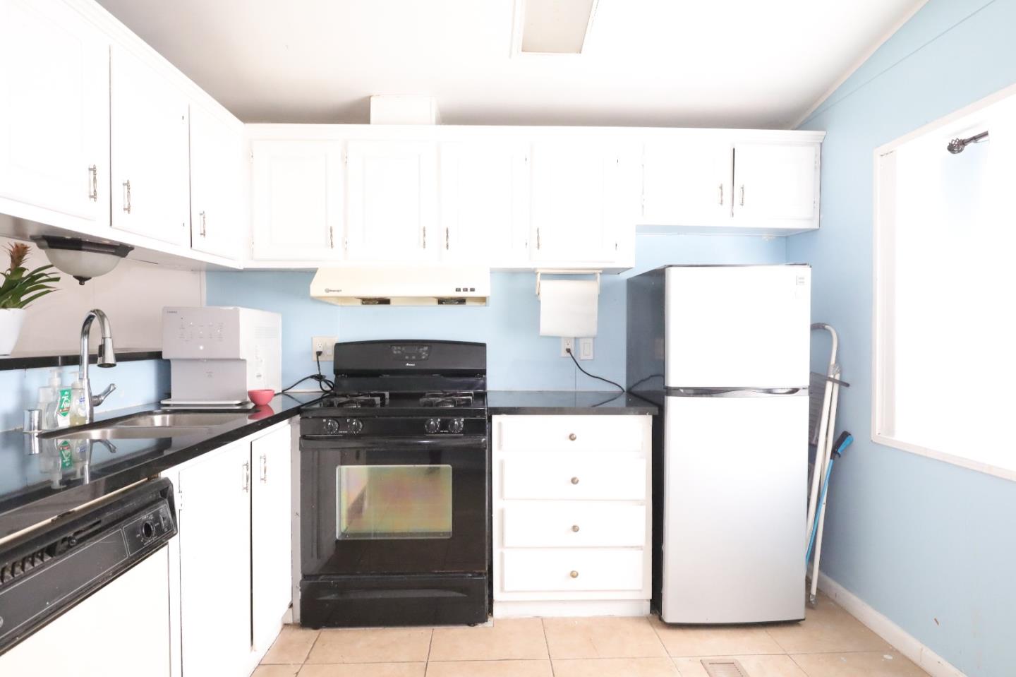 60 Wilson Way, Unit 150 Milpitas, CA 95035 - Photo 7 of 12 a kitchen with a stove a refrigerator and a sink