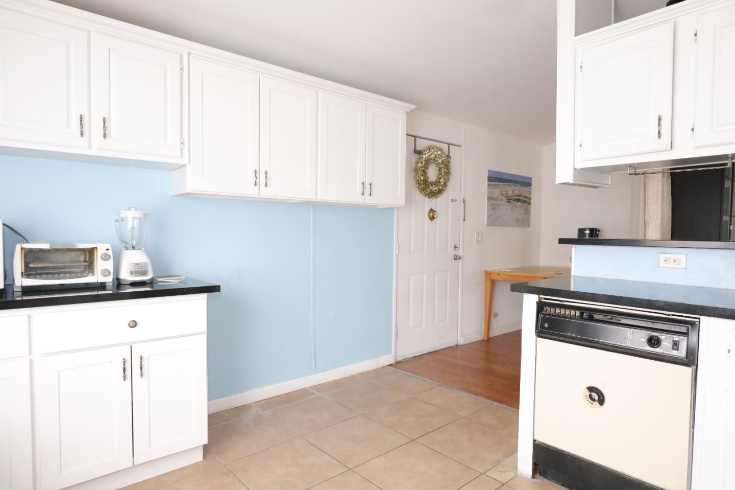 60 Wilson Way, Unit 150 Milpitas, CA 95035 - Photo 9 of 12 a kitchen with granite countertop white cabinets and white appliances