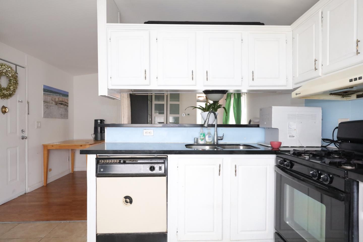 60 Wilson Way, Unit 150 Milpitas, CA 95035 - Photo 10 of 12 a kitchen with stainless steel appliances granite countertop a stove a sink and white cabinets
