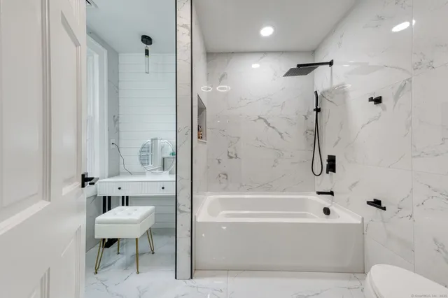 a bathroom with a bathtub and a toilet