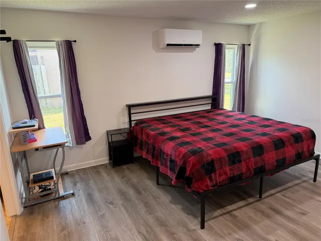 a bed sitting in a bedroom next to a window