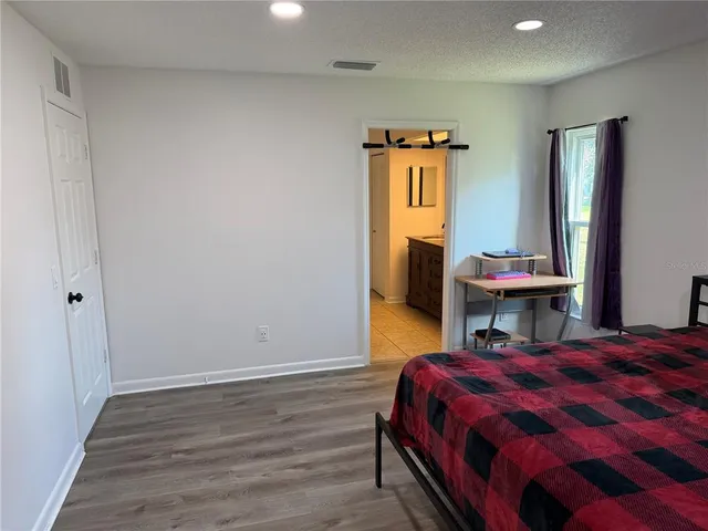 a bed room with a bed and a chair