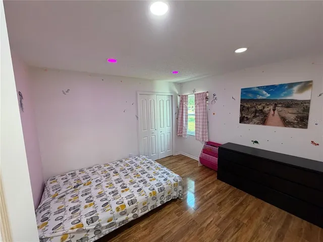 a bedroom with a bed and a dresser