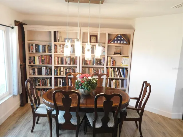 a dining room with furniture and wooden floor