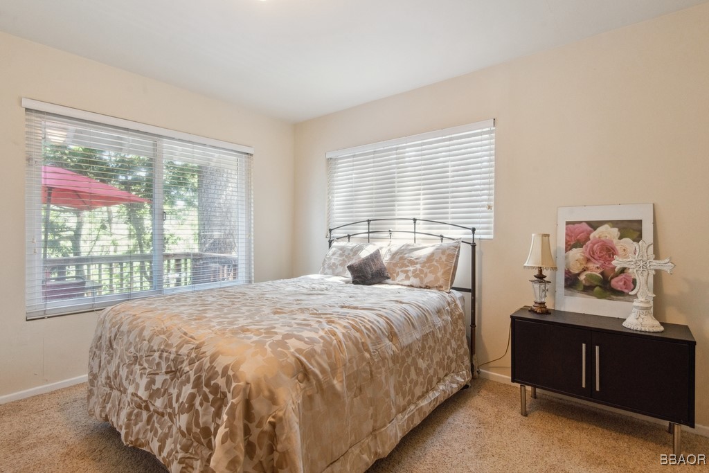 23697 Bowl Road Crestline, CA 92325 - Photo 17 of 28 a bedroom with a bed painting on the wall and a large window