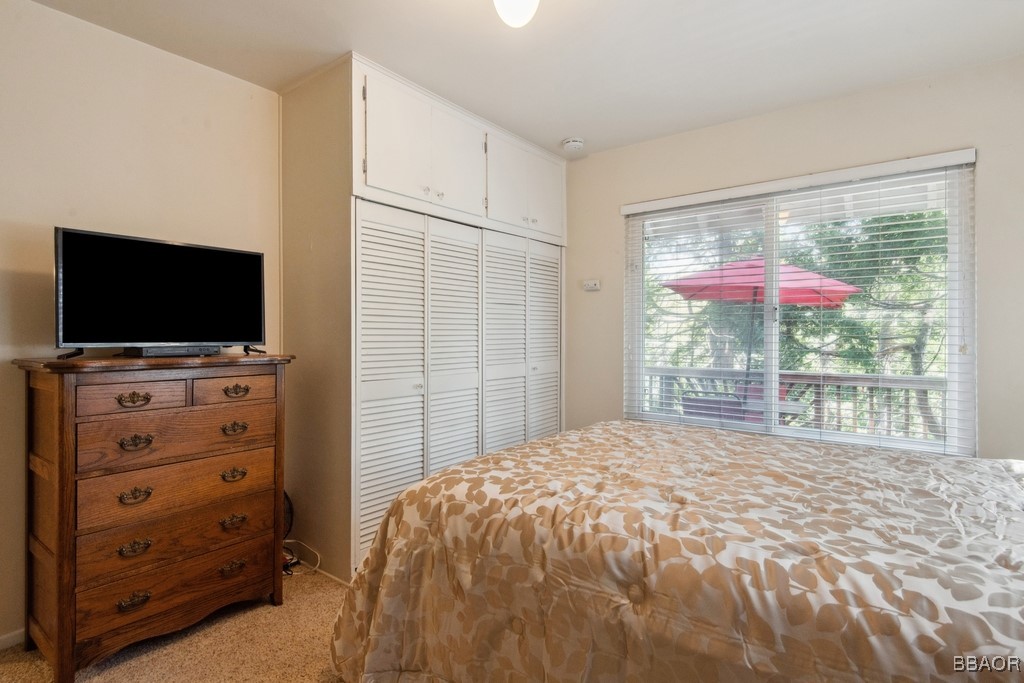 23697 Bowl Road Crestline, CA 92325 - Photo 18 of 28 a bedroom with a bed and a flat screen tv