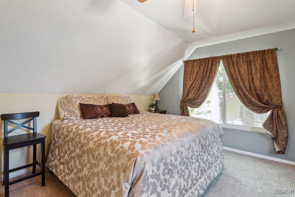 23697 Bowl Road Crestline, CA 92325 - Photo 20 of 28 a bedroom with a bed and a window with chair