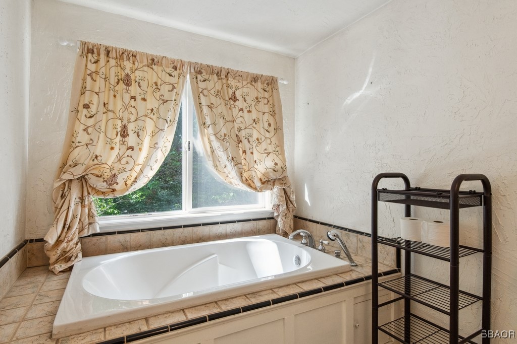23697 Bowl Road Crestline, CA 92325 - Photo 25 of 28 a bath tub sitting next to a window