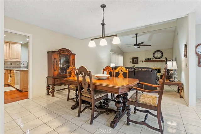 a view of a dining room and livingroom with furniture wooden floor a chandelier