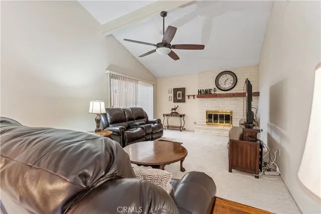 a living room with furniture a clock and a window