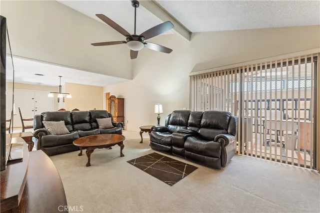 a living room with furniture and a ceiling fan